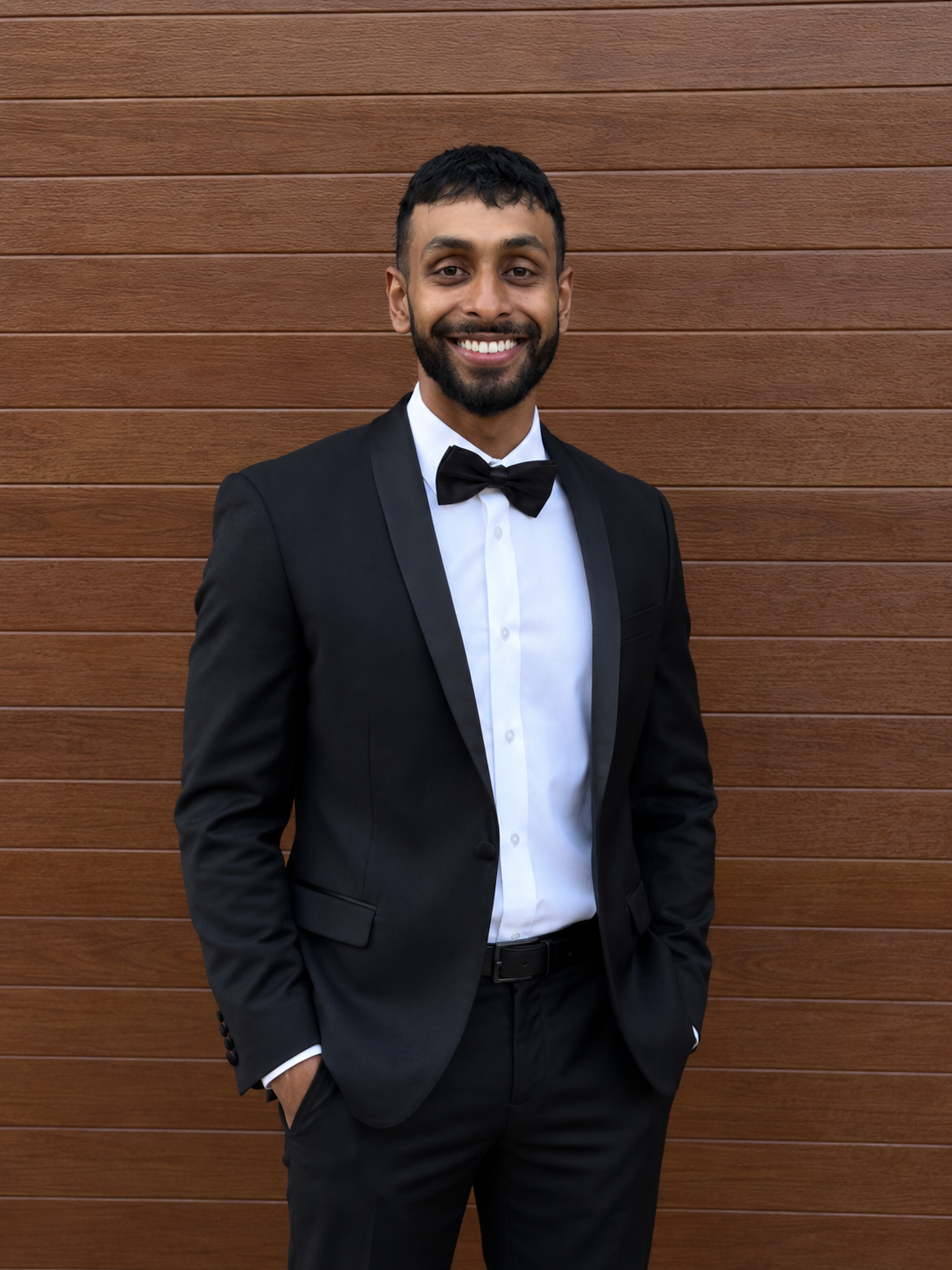 Dr Akith Nanayakkara smiling in a black suit